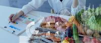 A scientist reviewing data next to a table full of nutritious foods, with graphs superimposed over them.