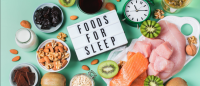An image of foods that support sleep, with a Foods For Sleep sign and a clock.