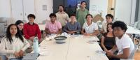 Group of CU-HERE students around a table.