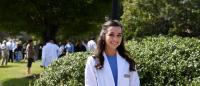 Image of Sarah Tydings in her white coat for medical school.